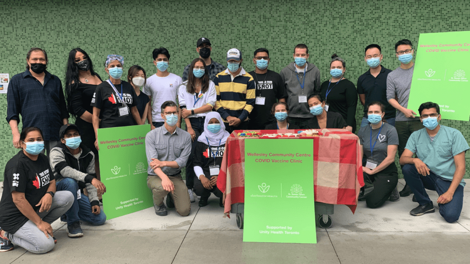 A group of people posing with masks on