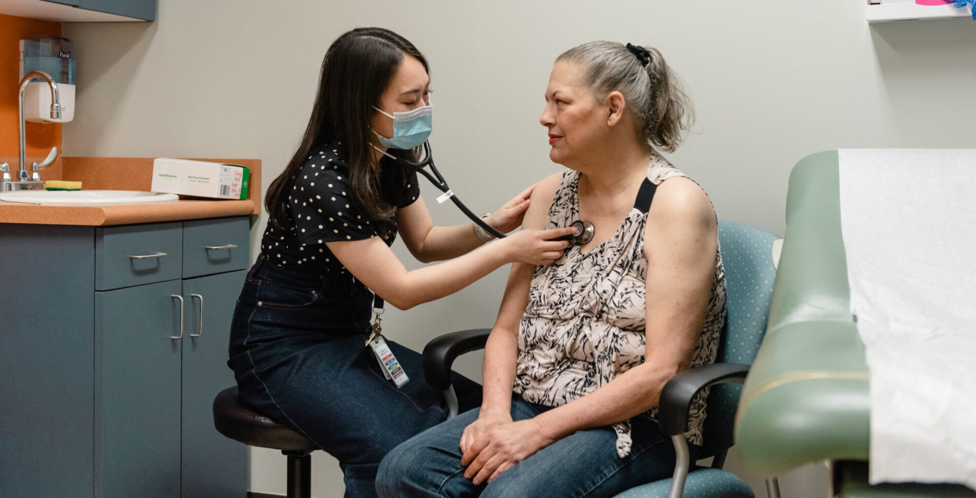 photo of a doctor using a stethoscope on a patient
