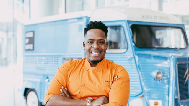 Chef Noel Cunningham smiling with his arms crossed.